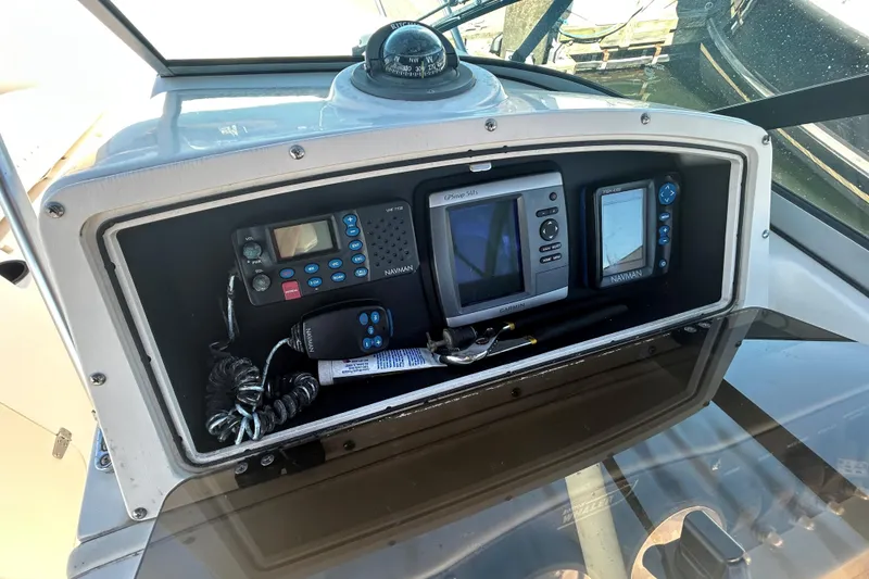 Slide: The Image of 2006 Boston Whaler 210 Ventura dashboard with navigation and communication equipment. - 14