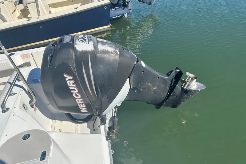 Slide: The Image of 2006 Boston Whaler 210 Ventura with Mercury outboard engine on calm water. - 16