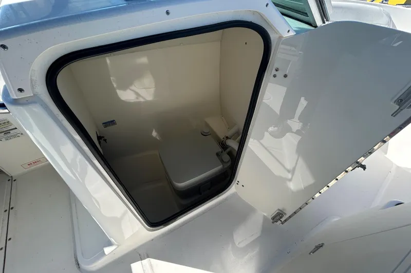 Slide: The Image of 2006 Boston Whaler 210 Ventura boat interior with open storage compartment. - 17