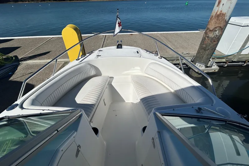 Slide: The Image of 2006 Boston Whaler 210 Ventura boat docked, featuring spacious seating and sleek design. - 6