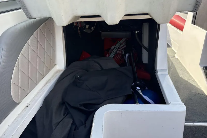 Slide: The Image of Storage compartment of a 2012 MasterCraft X-15 boat with various items inside. - 10