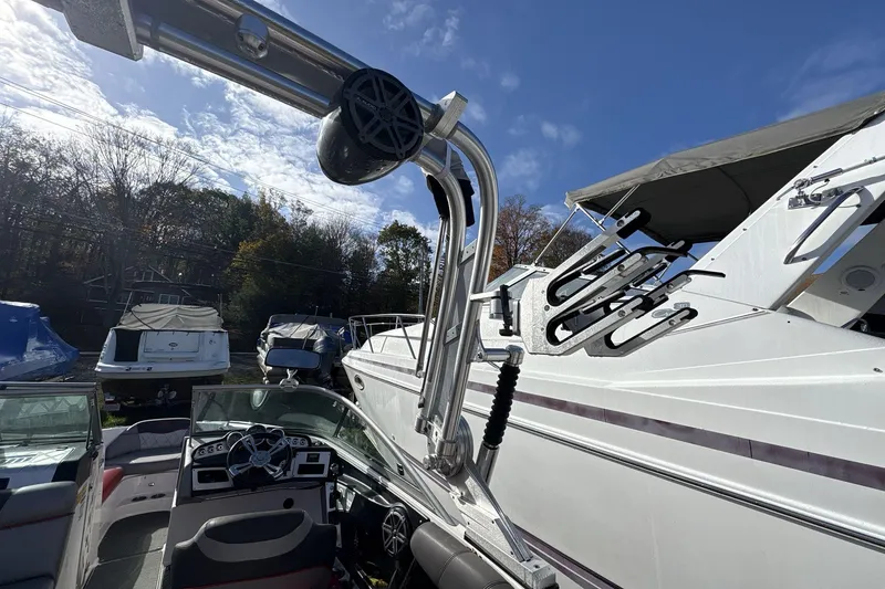 Slide: The Image of 2012 MasterCraft X-15 boat interior with wakeboard tower, parked among other boats. - 12