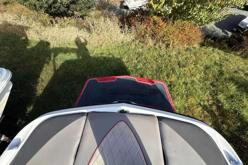 Slide: The Image of 2012 MasterCraft X-15 boat interior with grass and shadows in the background. - 2