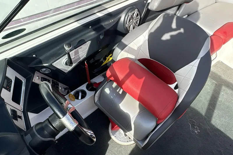 Slide: The Image of 2012 MasterCraft X-15 boat interior with steering wheel and red-gray seating. - 4