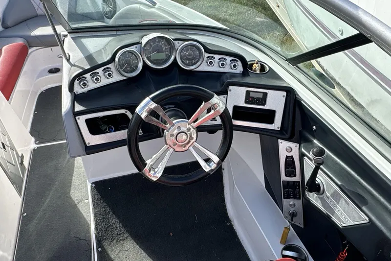Slide: The Image of 2012 MasterCraft X-15 boat dashboard with steering wheel and control panel. - 6