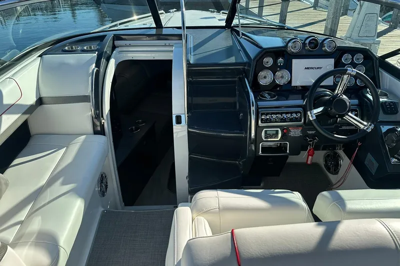 Slide: The Image of 2018 Formula 290 Sun Sport boat interior with steering wheel and dashboard controls. - 10