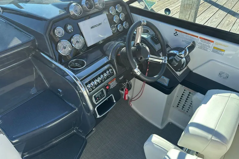 Slide: The Image of 2018 Formula 290 Sun Sport boat cockpit with steering wheel and control panel. - 12