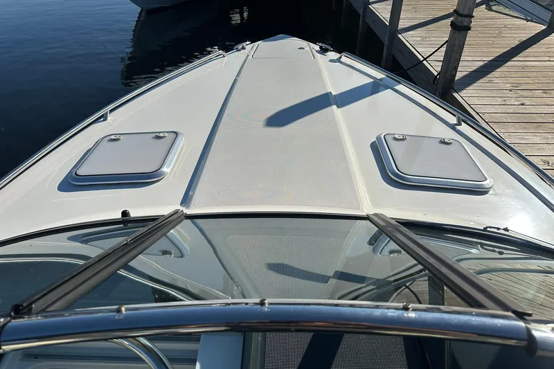Slide: The Image of 2018 Formula 290 Sun Sport boat deck at marina, featuring sleek design and hatches. - 13