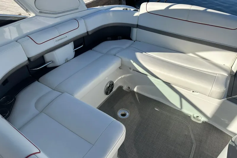 Slide: The Image of 2018 Formula 290 Sun Sport boat interior with white cushioned seating and gray flooring. - 16