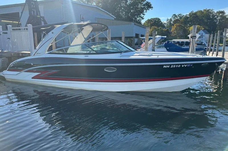 Slide: The Image of 2018 Formula 290 Sun Sport boat docked on calm water, side view. - 2