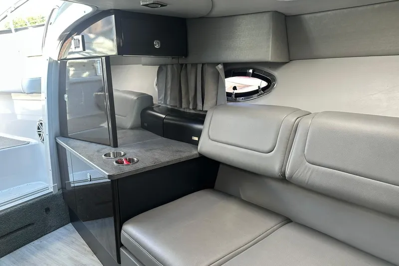 Slide: The Image of 2018 Formula 290 Sun Sport interior with gray seating and compact cabin amenities. - 20