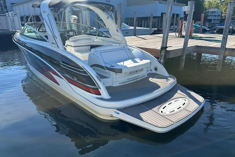 Slide: The Image of 2018 Formula 290 Sun Sport boat docked at marina, rear view. - 3