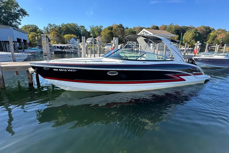 Slide: The Image of 2018 Formula 290 Sun Sport boat docked in a scenic marina setting. - 4