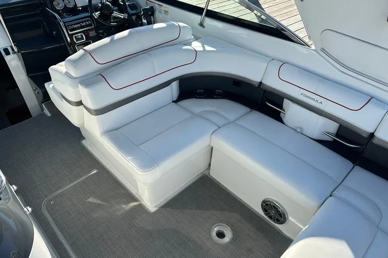 Slide: The Image of 2018 Formula 290 Sun Sport boat interior with white seating and modern dashboard. - 8