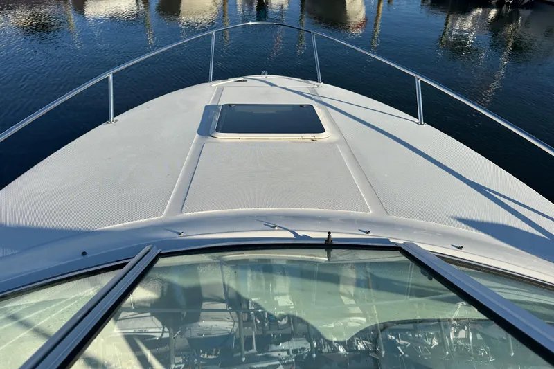 Slide: The Image of 2001 Sea Ray 240 Sundancer boat deck with water reflection in marina. - 2