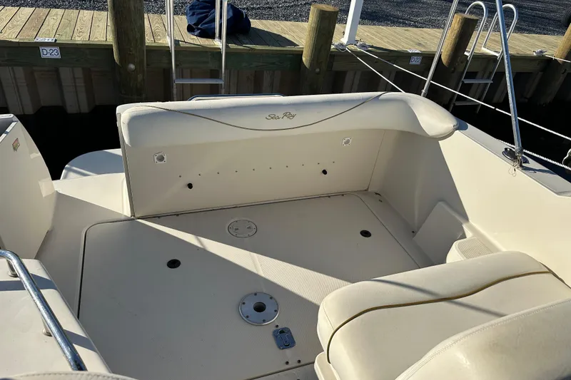 Slide: The Image of 2001 Sea Ray 240 Sundancer boat interior with seating and dock view. - 4