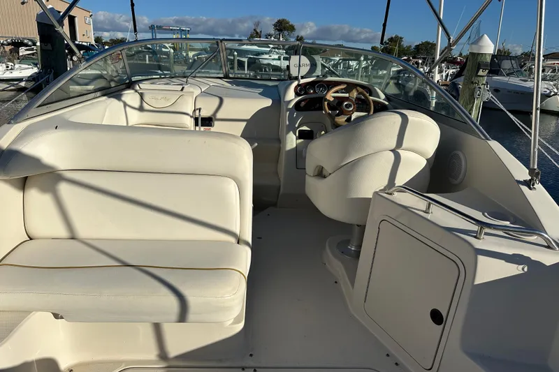 Slide: The Image of 2001 Sea Ray 240 Sundancer boat interior with helm and seating area. - 6