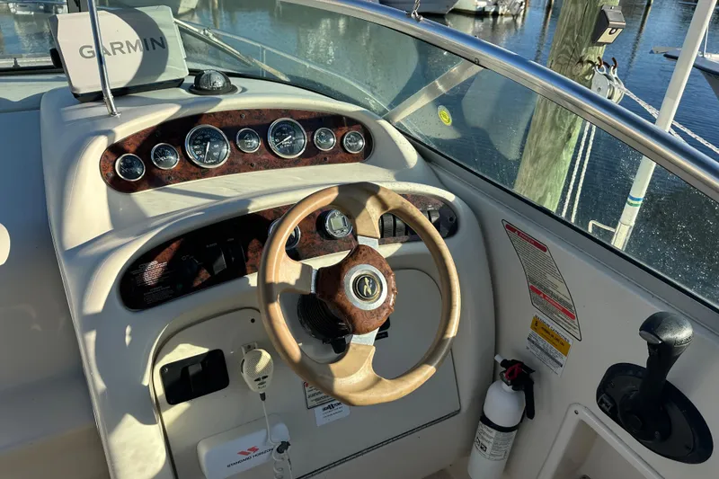 Slide: The Image of 2001 Sea Ray 240 Sundancer boat dashboard with Garmin GPS and wooden steering wheel. - 8