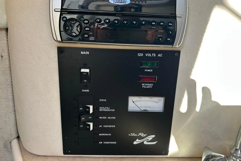 Slide: The Image of Control panel of a 2001 Sea Ray 240 Sundancer boat with power switches. - 9