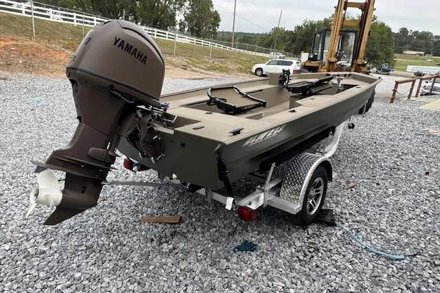 Slide: The Image of 2025 Alweld 1752PF boat with Yamaha motor on a trailer, parked on gravel. - 4