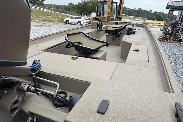 Slide: The Image of 2025 Alweld 1752PF boat interior with seating and equipment, parked on gravel. - 5