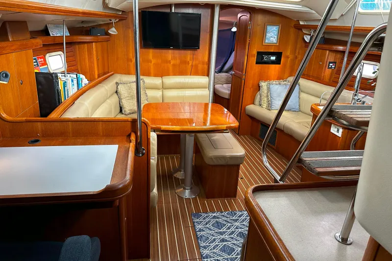 Slide: The Image of Luxurious interior of a 2006 Hunter 45 CC yacht with wood finishes and cozy seating. - 17