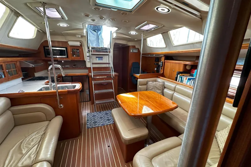 Slide: The Image of Luxurious interior of a 2006 Hunter 45 CC yacht with elegant wood finishes and cozy seating. - 19