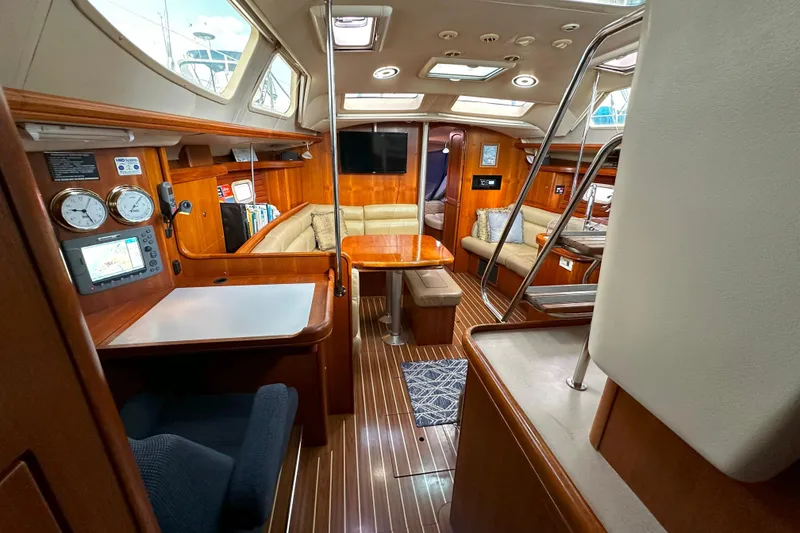 Slide: The Image of Interior of 2006 Hunter 45 CC yacht with wood finish and cozy seating area. - 20