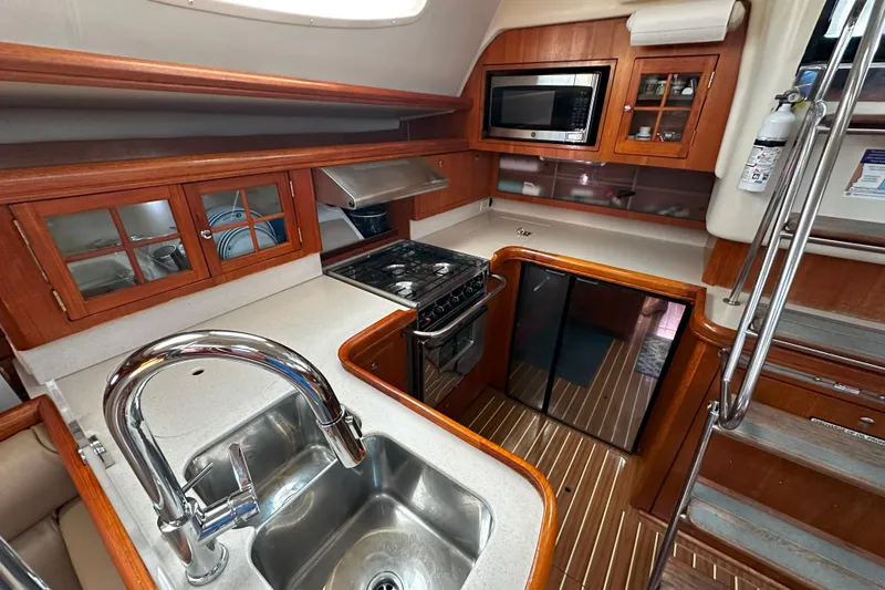 Slide: The Image of Luxurious 2006 Hunter 45 CC yacht kitchen with modern appliances and wooden cabinetry. - 21