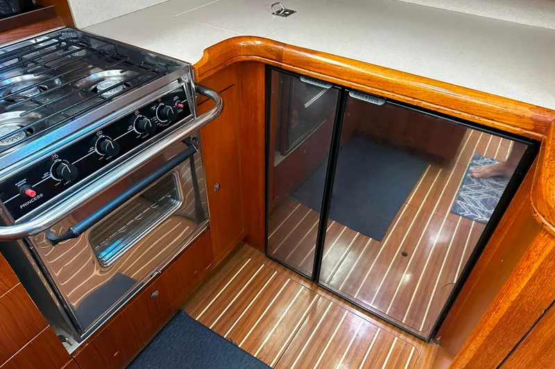 Slide: The Image of Galley kitchen in 2006 Hunter 45 CC yacht with stove and wood flooring. - 26