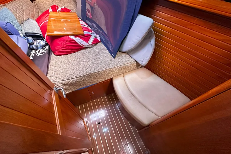 Slide: The Image of Cozy cabin interior of 2006 Hunter 45 CC sailboat with wooden paneling and bedding. - 33