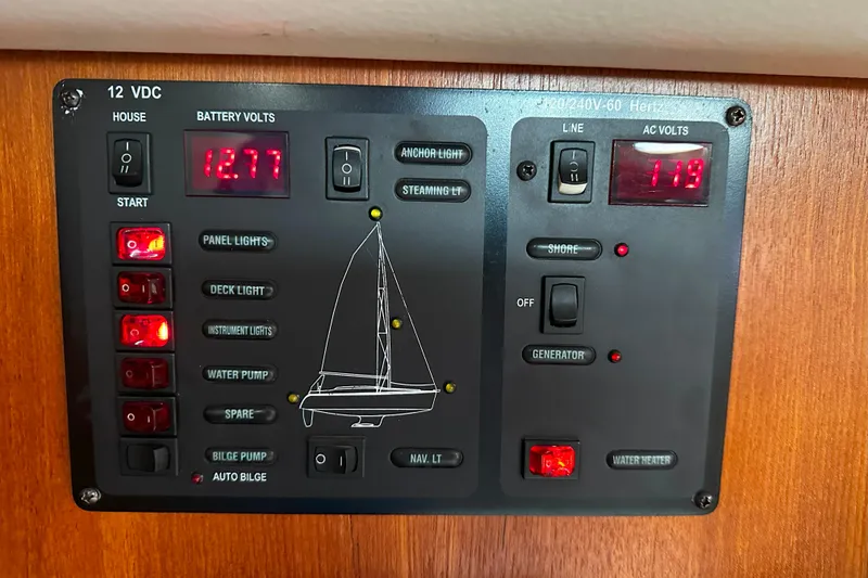 Slide: The Image of Electrical control panel on a 2006 Hunter 45 CC sailboat, displaying battery and AC voltage. - 41