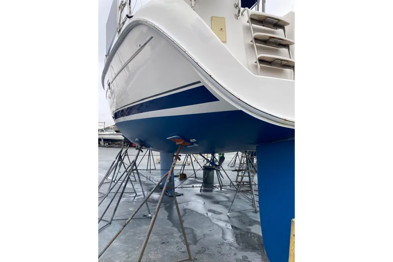 Slide: The Image of Hunter 45 CC sailboat, 2006 model, on stands for maintenance, showcasing blue hull. - 52