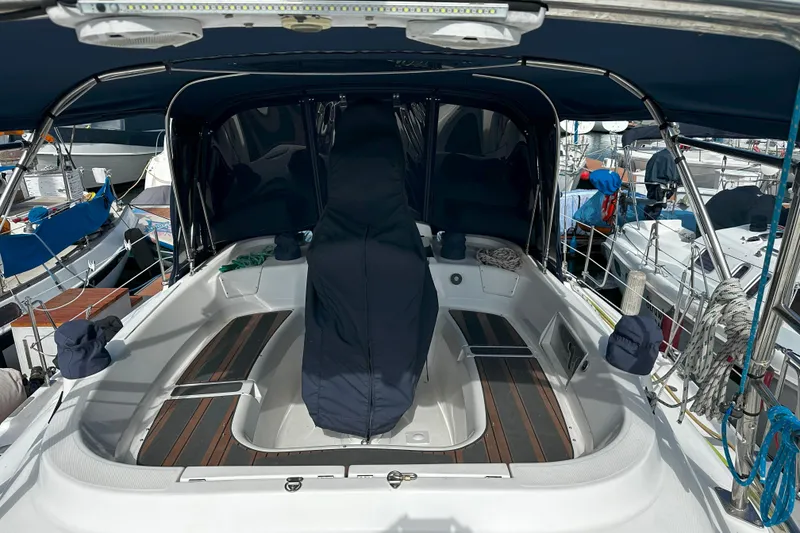 Slide: The Image of Cockpit of 2006 Hunter 45 CC sailboat with covered helm and seating area. - 58