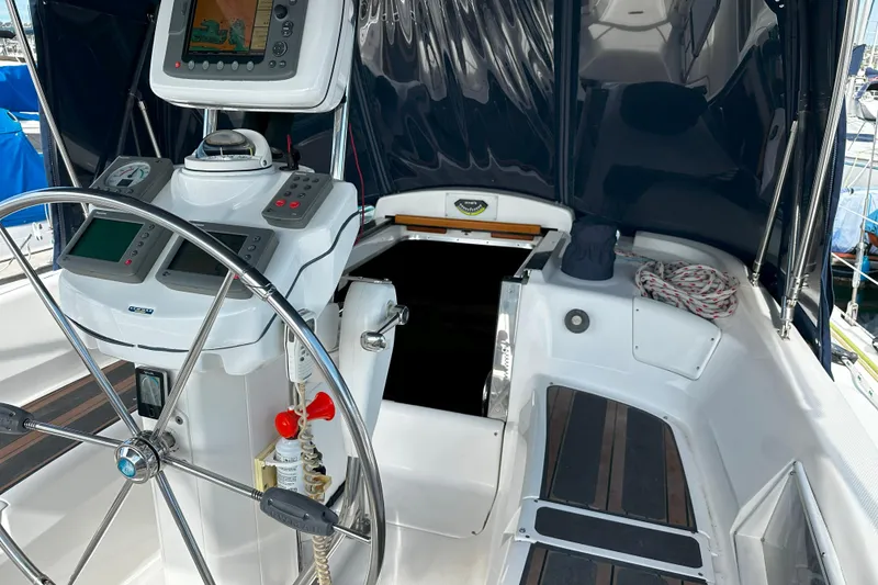 Slide: The Image of Cockpit of 2006 Hunter 45 CC sailboat with navigation equipment and steering wheel. - 59