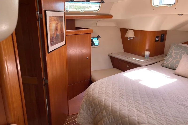 Slide: The Image of Cozy cabin interior of 2006 Hunter 45 CC sailboat with wood accents and comfortable bedding. - 6