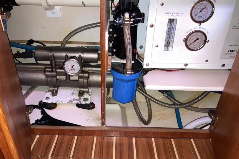 Slide: The Image of Water filtration system inside a 2006 Hunter 45 CC yacht, featuring gauges and pipes. - 64