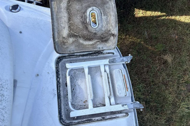 Slide: The Image of 2007 Four Winns 200 Horizon boat ladder and hatch, showing wear and outdoor exposure. - 16