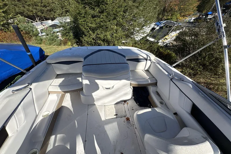 Slide: The Image of 2007 Four Winns 200 Horizon boat interior with white seating and outdoor setting. - 17