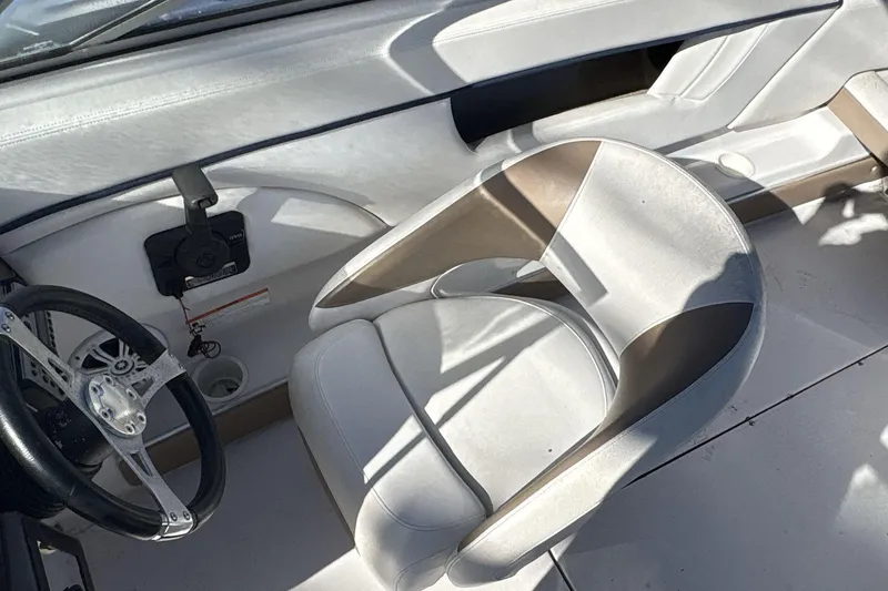 Slide: The Image of Interior of a 2007 Four Winns 200 Horizon boat, featuring a steering wheel and seat. - 7