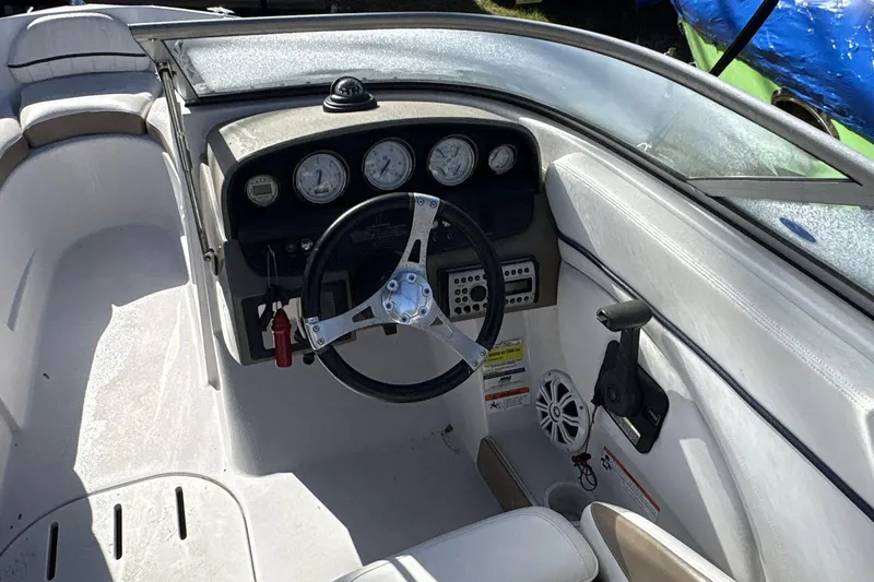 Slide: The Image of 2007 Four Winns 200 Horizon boat cockpit with steering wheel and dashboard gauges. - 9