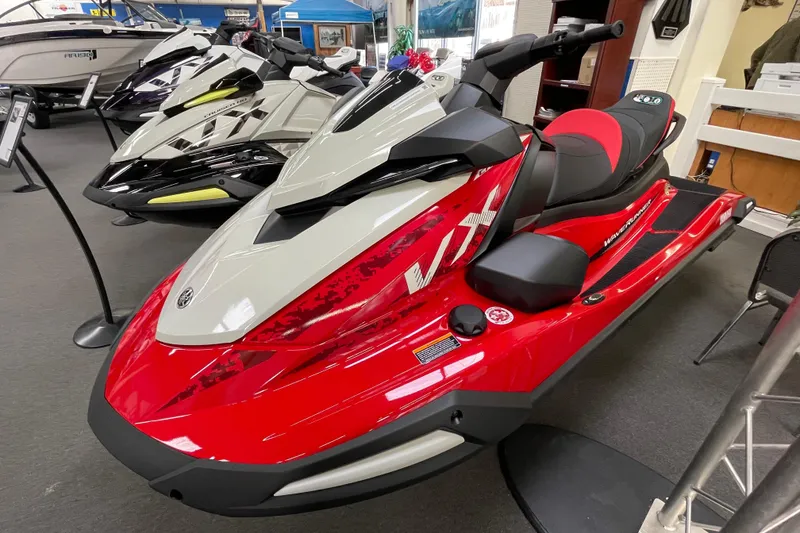 Slide: The Image of 2026 Yamaha WaveRunner VX Cruiser in showroom, red and white design, sleek and modern. - 2