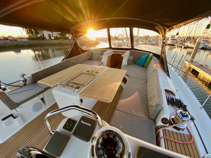 Slide: The Image of Luxurious 2016 Jeanneau 54 yacht interior with sunset view, featuring spacious seating and elegant design. - 10