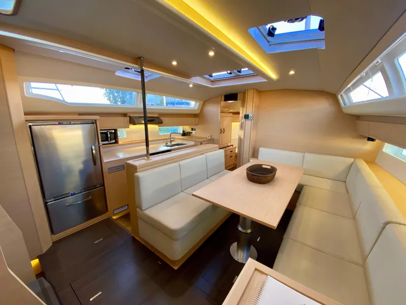 Slide: The Image of Luxurious interior of a 2016 Jeanneau 54 yacht with modern kitchen and seating area. - 15