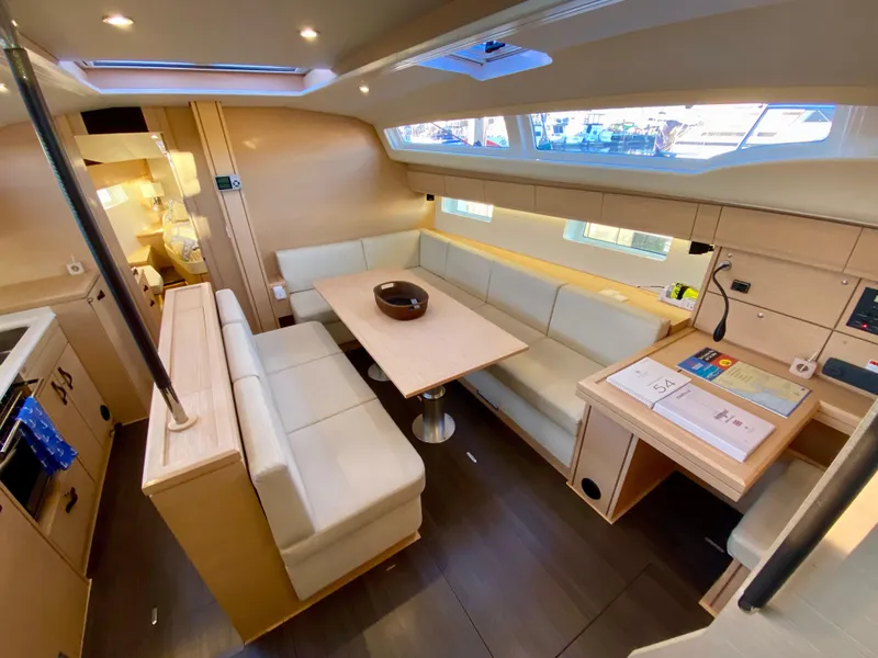 Slide: The Image of Luxurious interior of a 2016 Jeanneau 54 yacht with elegant seating and dining area. - 17
