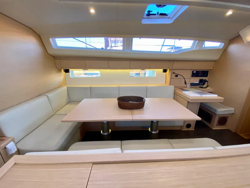 Slide: The Image of Interior of 2016 Jeanneau 54 yacht with modern seating and dining area. - 19