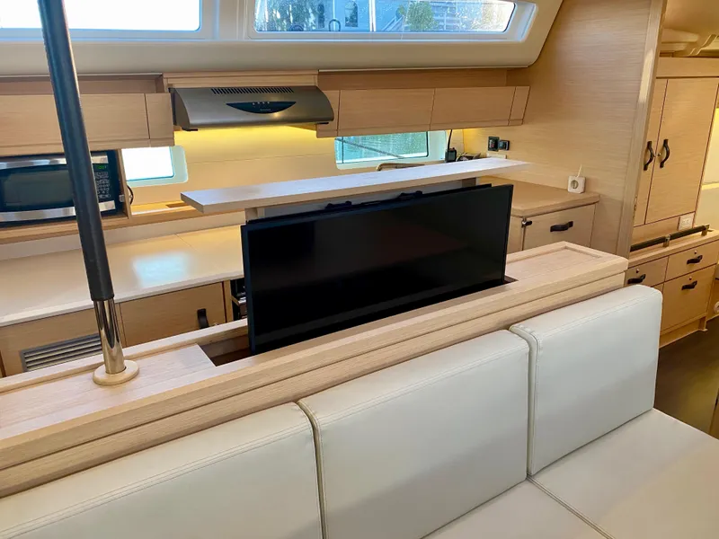Slide: The Image of Interior of 2016 Jeanneau 54 yacht with modern kitchen and pop-up TV. - 22
