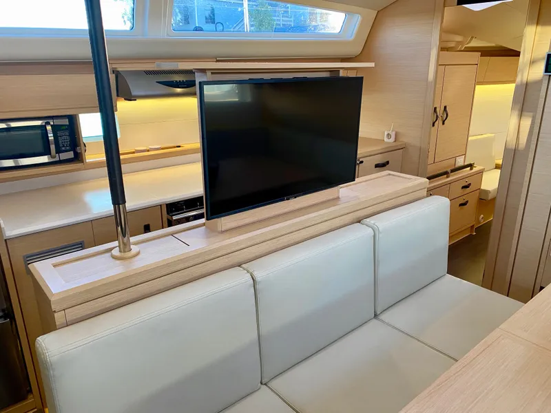 Slide: The Image of Interior of 2016 Jeanneau 54 yacht with modern kitchen and retractable TV. - 23