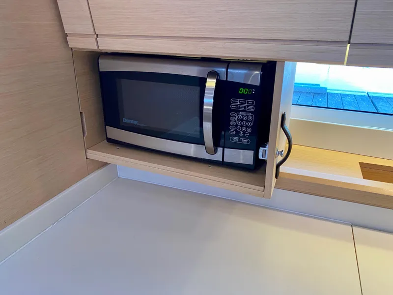 Slide: The Image of Microwave in Jeanneau 54 yacht kitchen, 2016 model, with light wood cabinetry. - 26