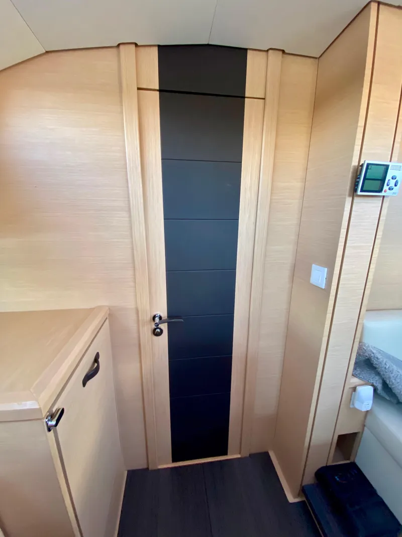 Slide: The Image of Interior of 2016 Jeanneau 54 yacht with modern wood finish and sleek door design. - 31